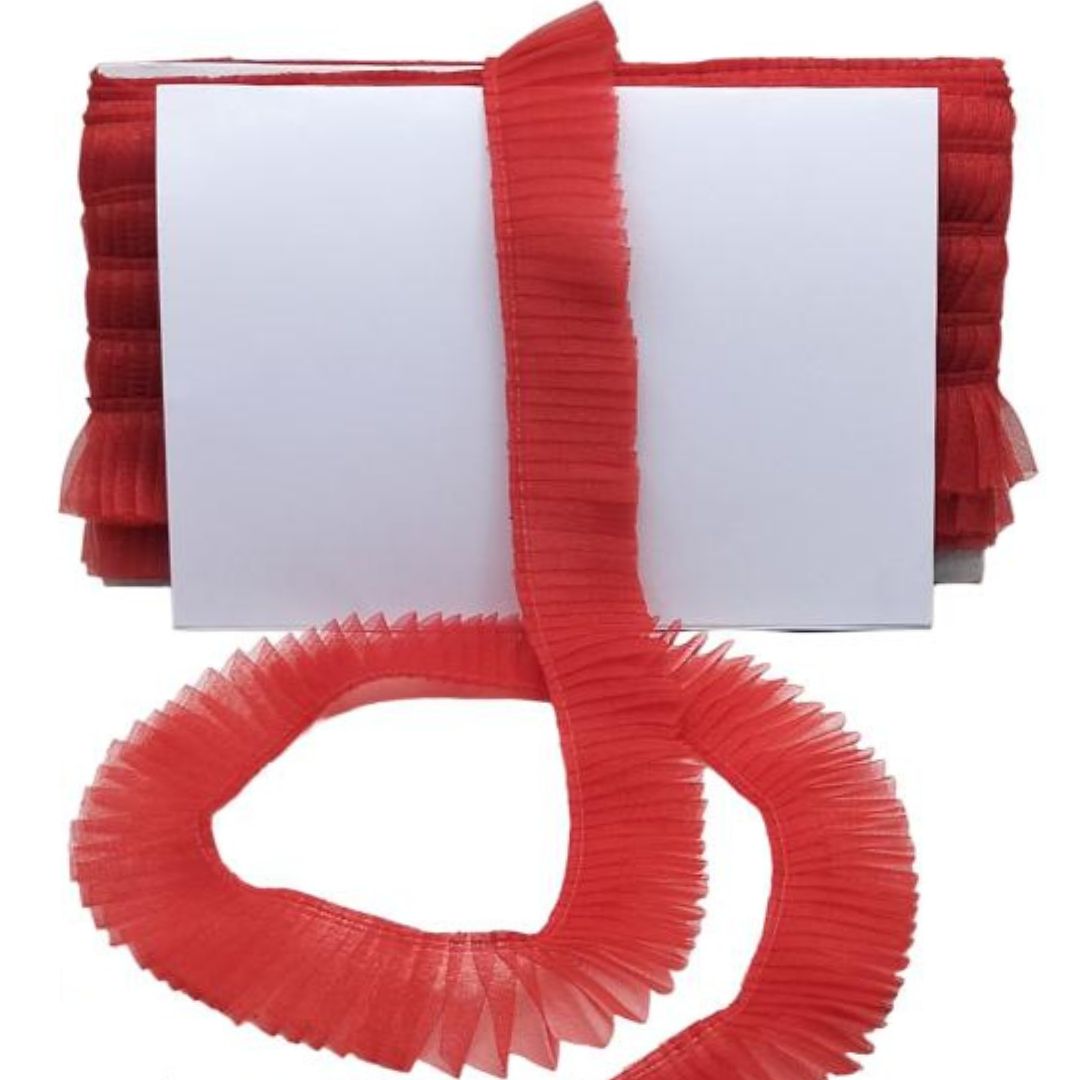 Red pleated ribbon with a white card on a white background