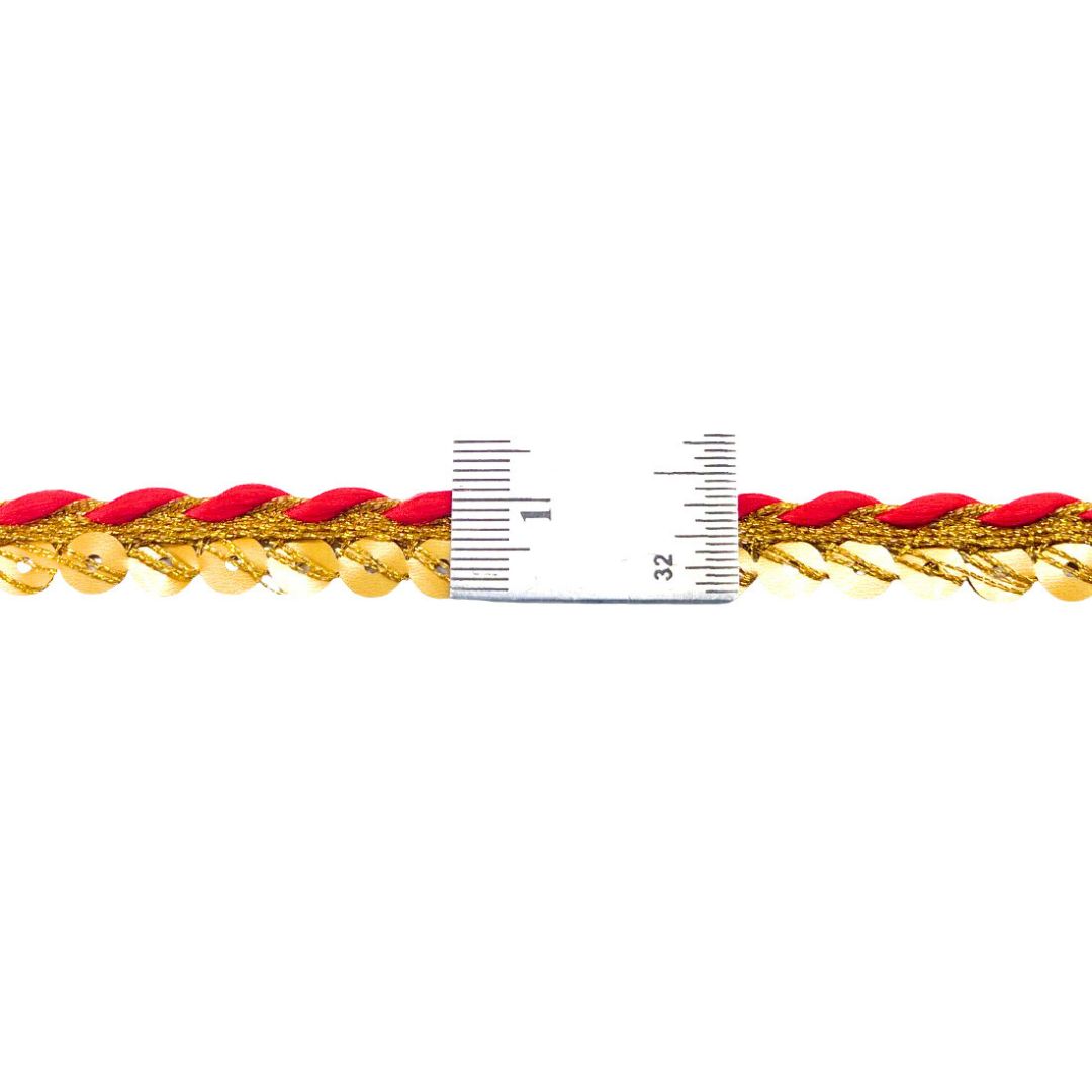 Gold and red braided cord with a ruler for scale on a white background