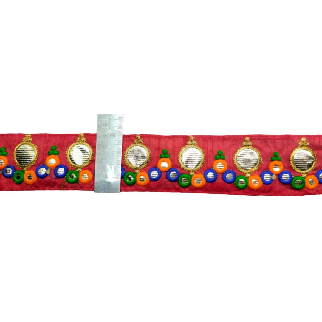 Decorative belt with colorful patterns on a red background