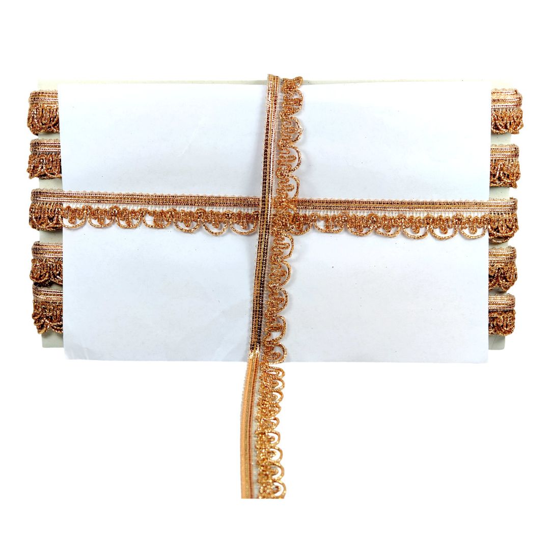 White pillow with gold decorative trim on a white background