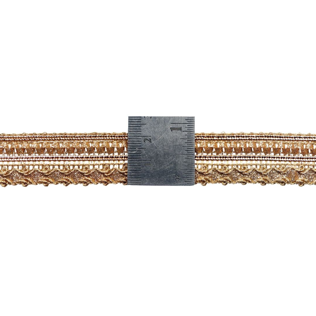 Gold decorative trim with a ruler for scale on a white background