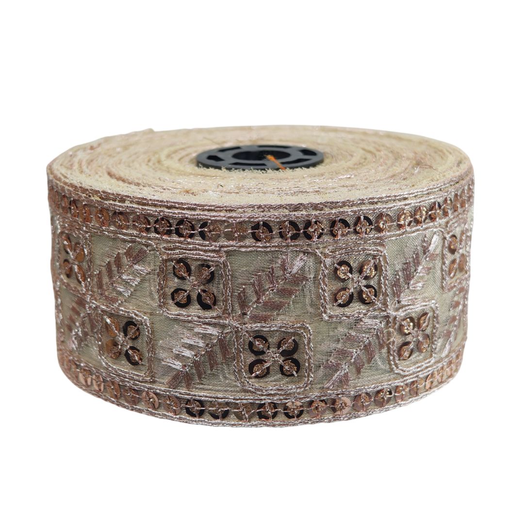 Roll of decorative ribbon with intricate patterns on a white background