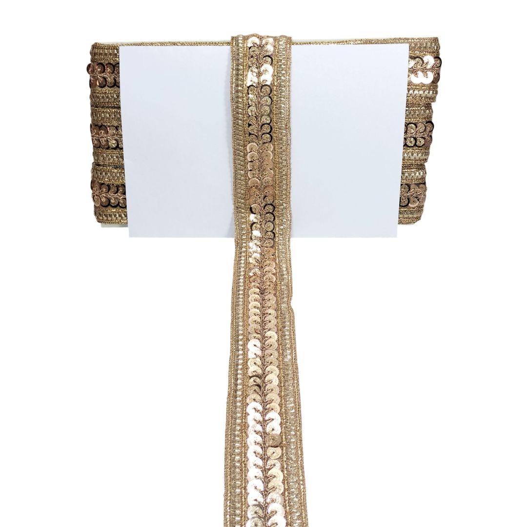 Decorative gold lace ribbon on a white background