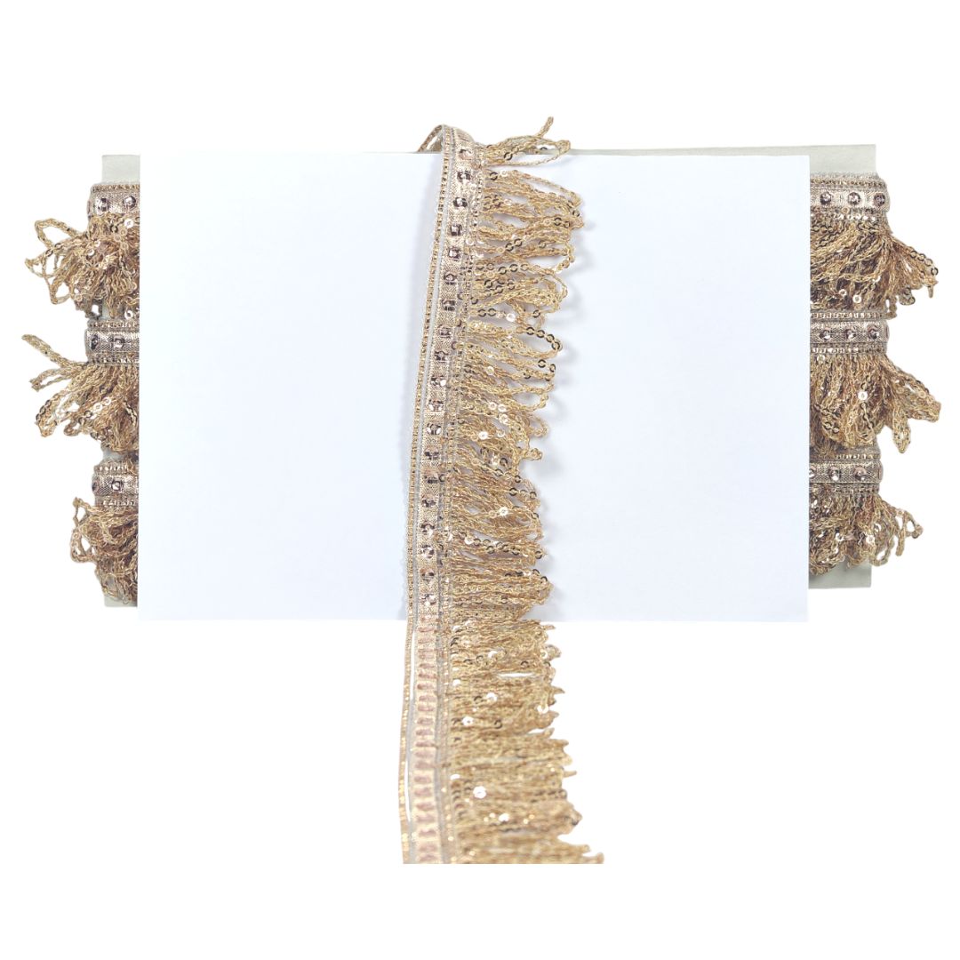 Decorative trim with gold tassels and beads on a white background