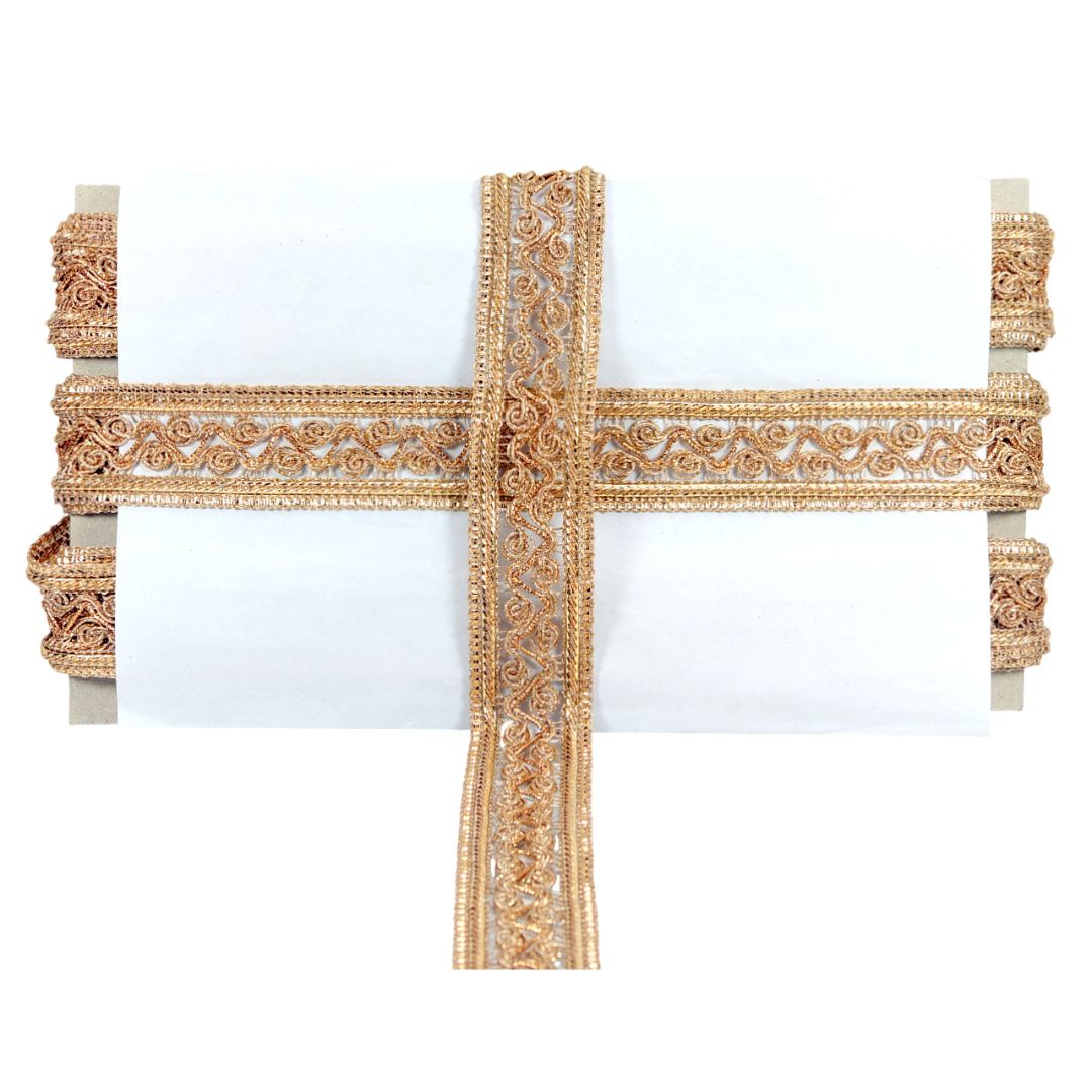 Decorative cross with intricate gold patterns on a white background