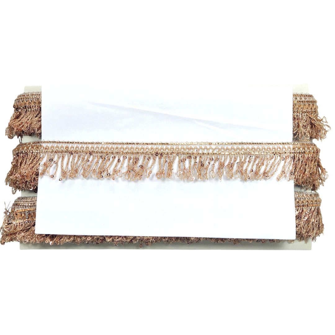 Bed with white bedding and brown fringed headboard and footboard on a white background