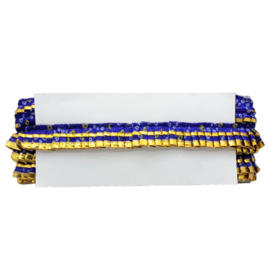 Clutch bag with blue and gold ruched detailing on a white background