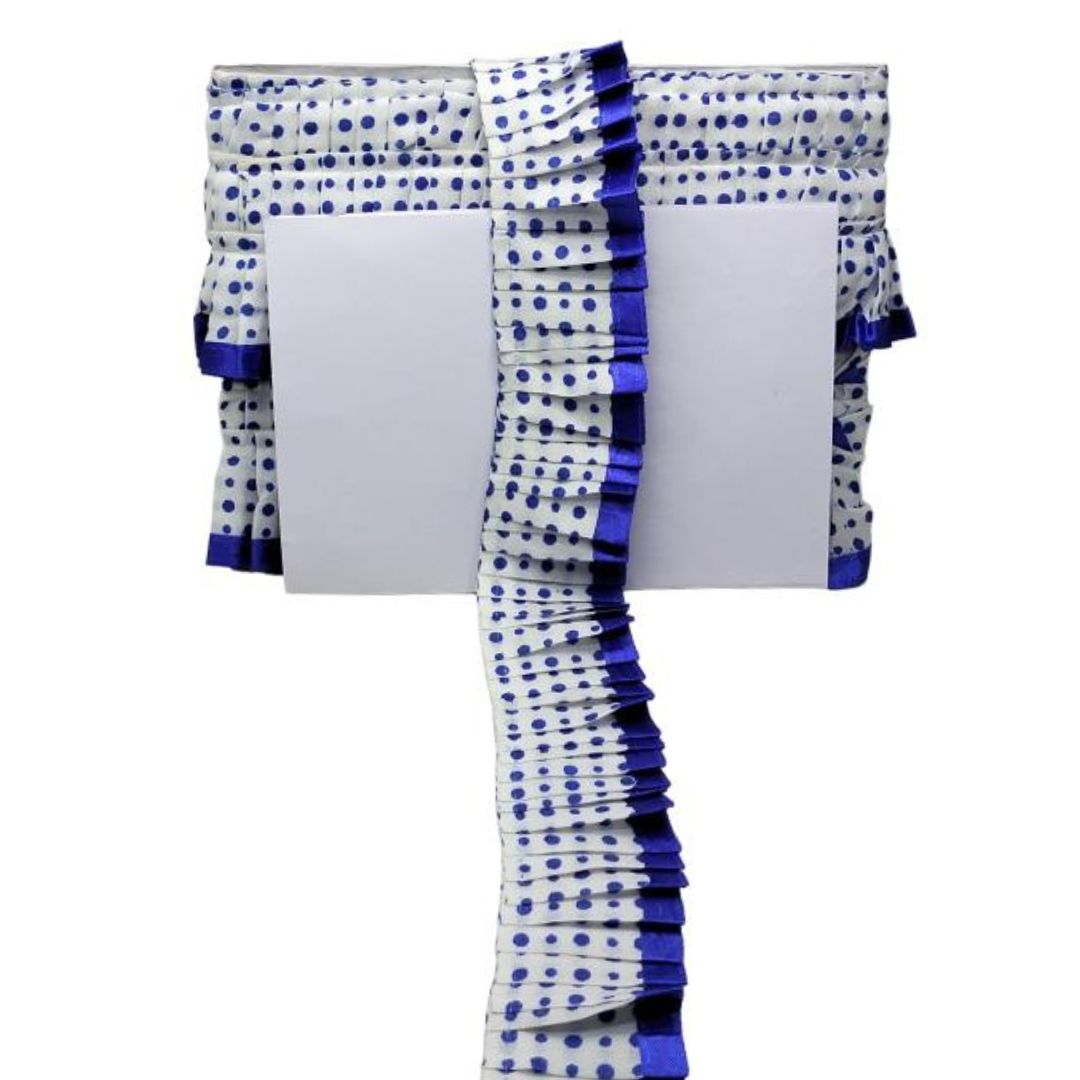 White saree with blue polka dots and border on a white background