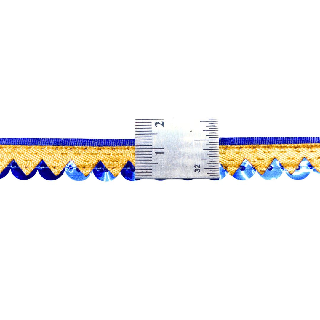 Close-up of blue and gold decorative ribbon with a ruler for scale on a white background