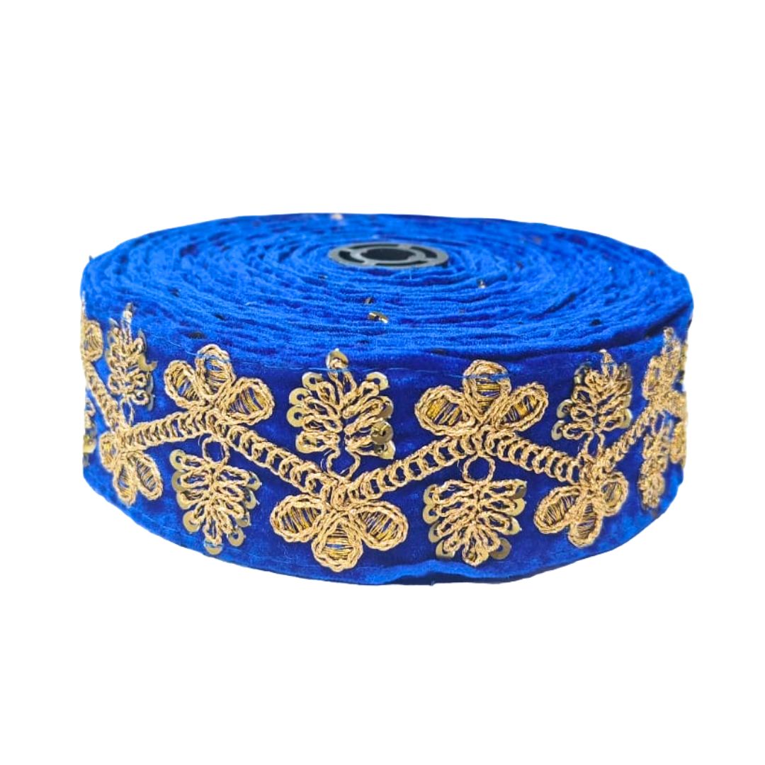 Roll of blue ribbon with gold floral embroidery on a white background