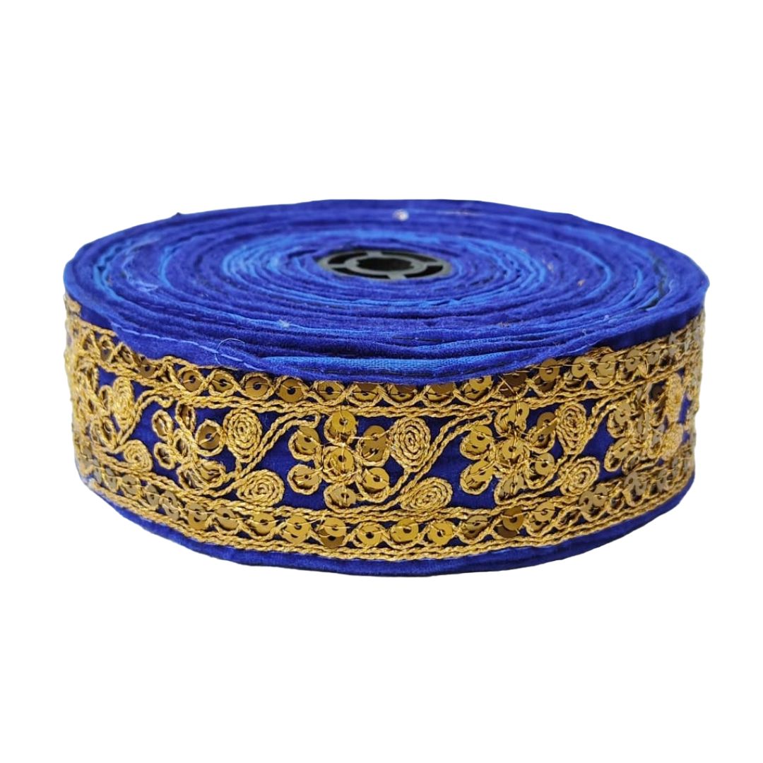 Roll of blue fabric with gold embroidery on a white background