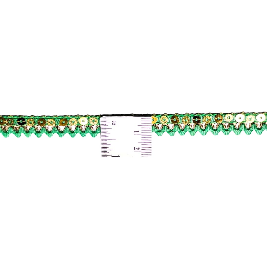 Decorative trim with floral pattern and ruler for scale on a white background