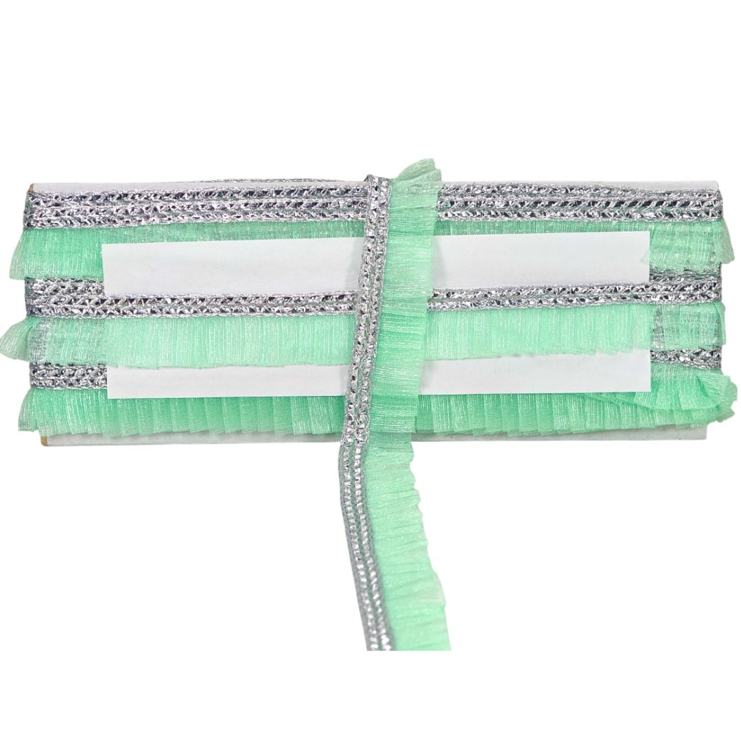 Green and silver decorative item on a white background