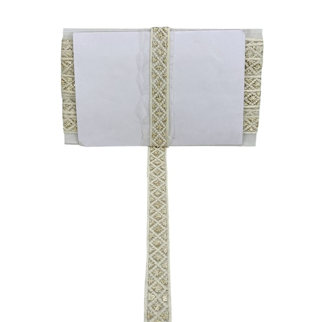 White pillow with decorative beige trim on a white background