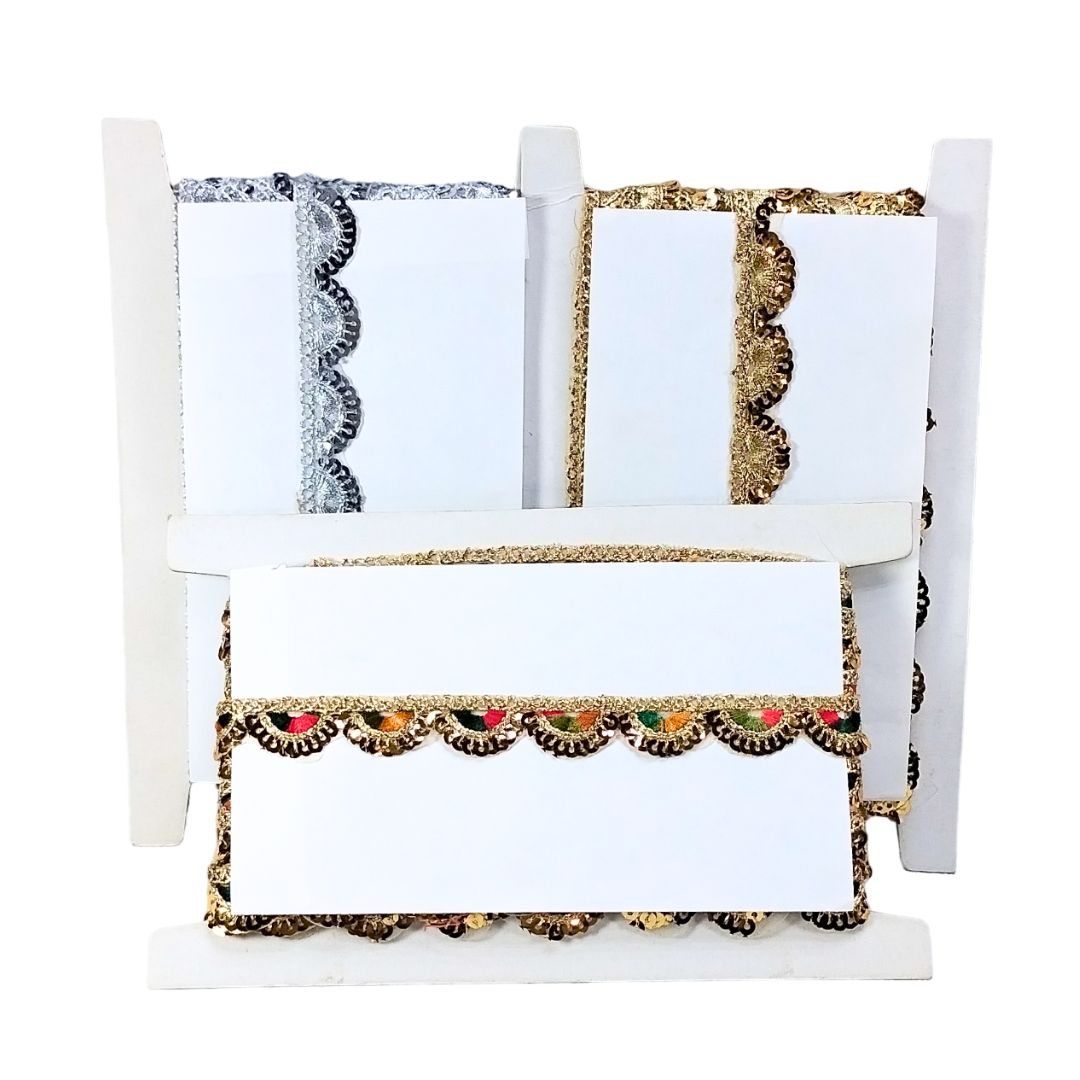 White crib with decorative bedding featuring gold trim and colorful accents on a white background