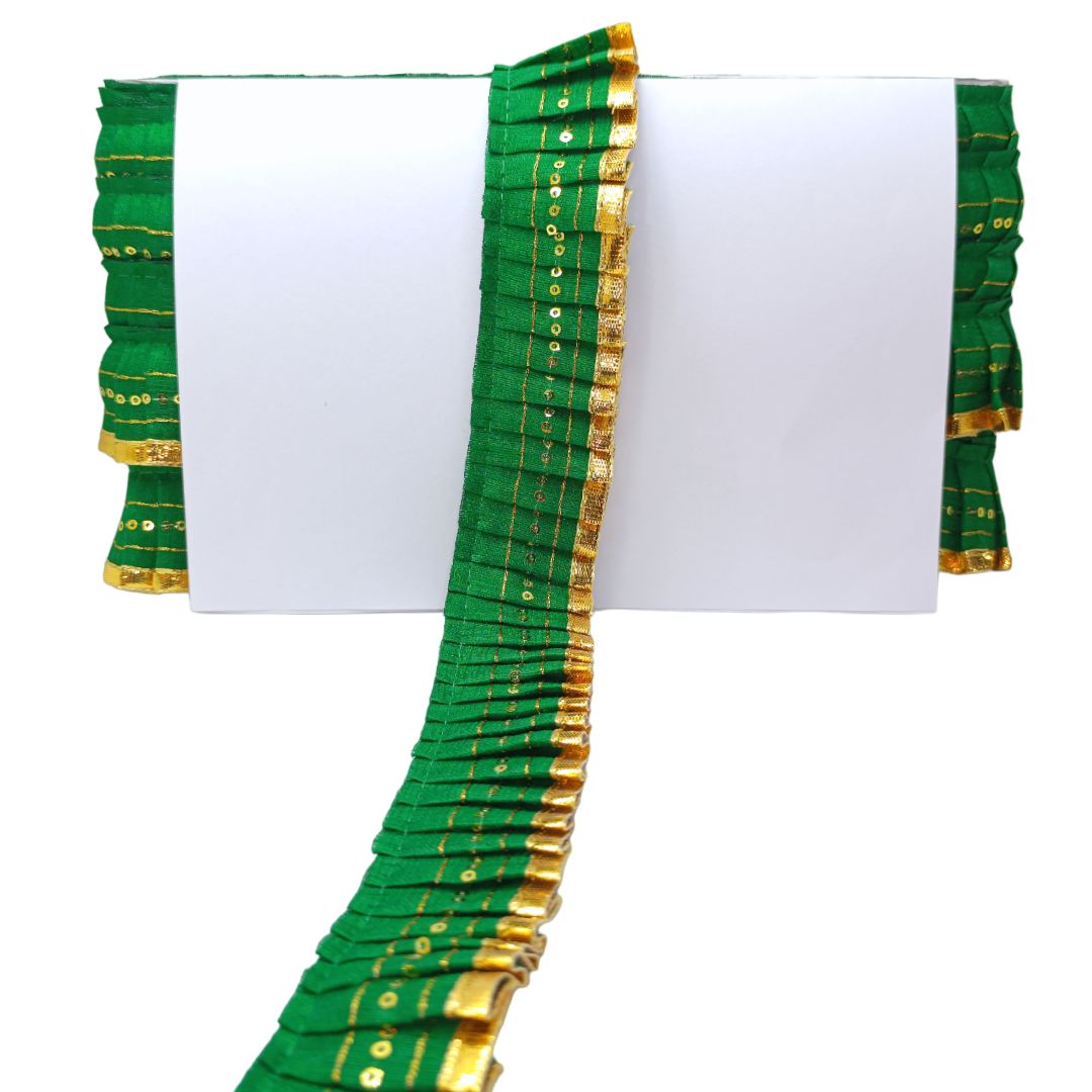 Green and gold saree border on a white background