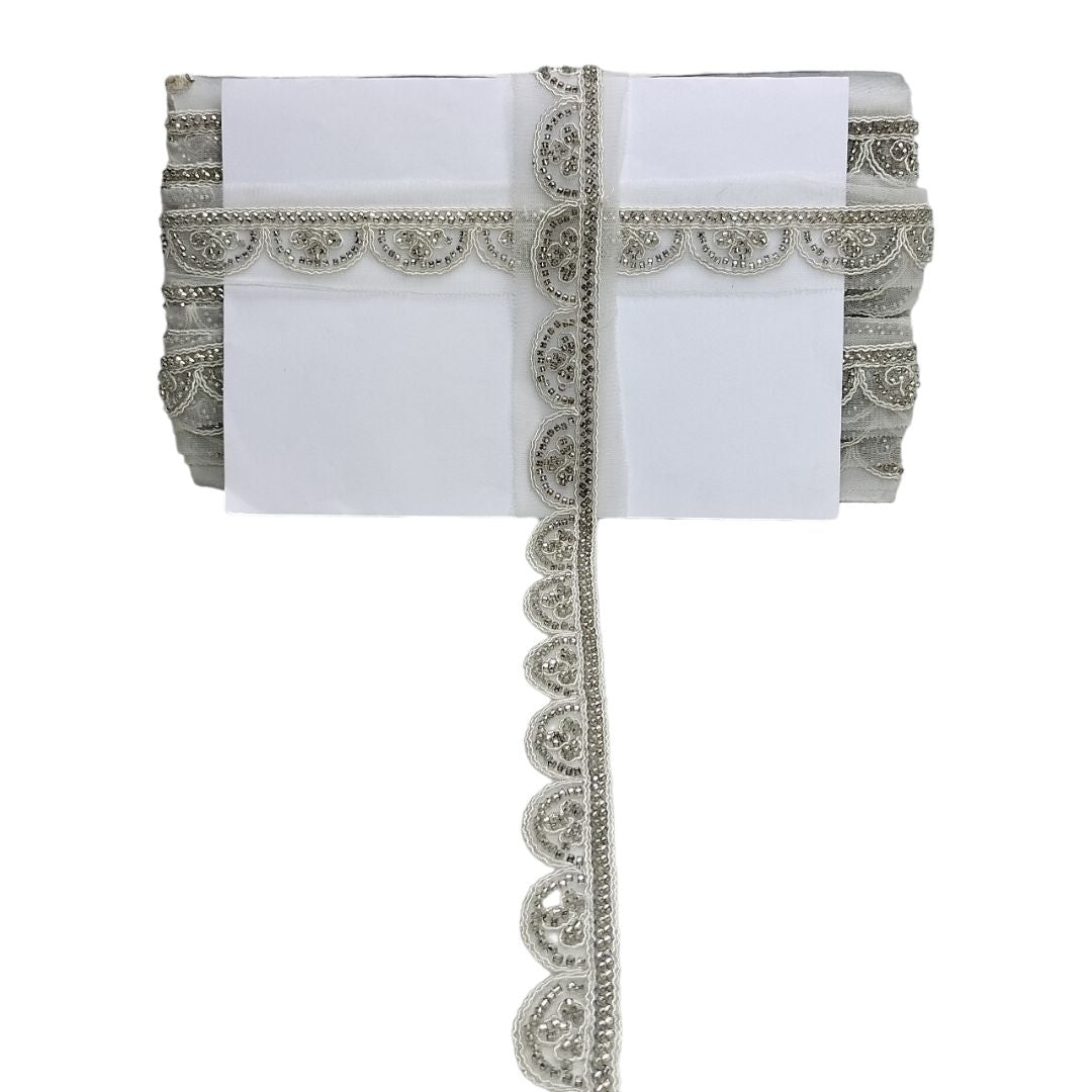 White fabric with silver decorative border on a white background