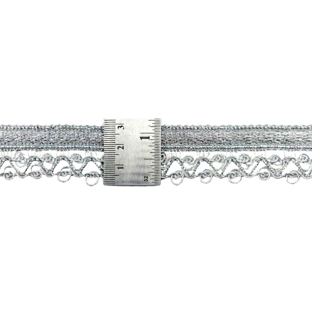 Silver metallic lace trim with a ruler for measurement on a white background