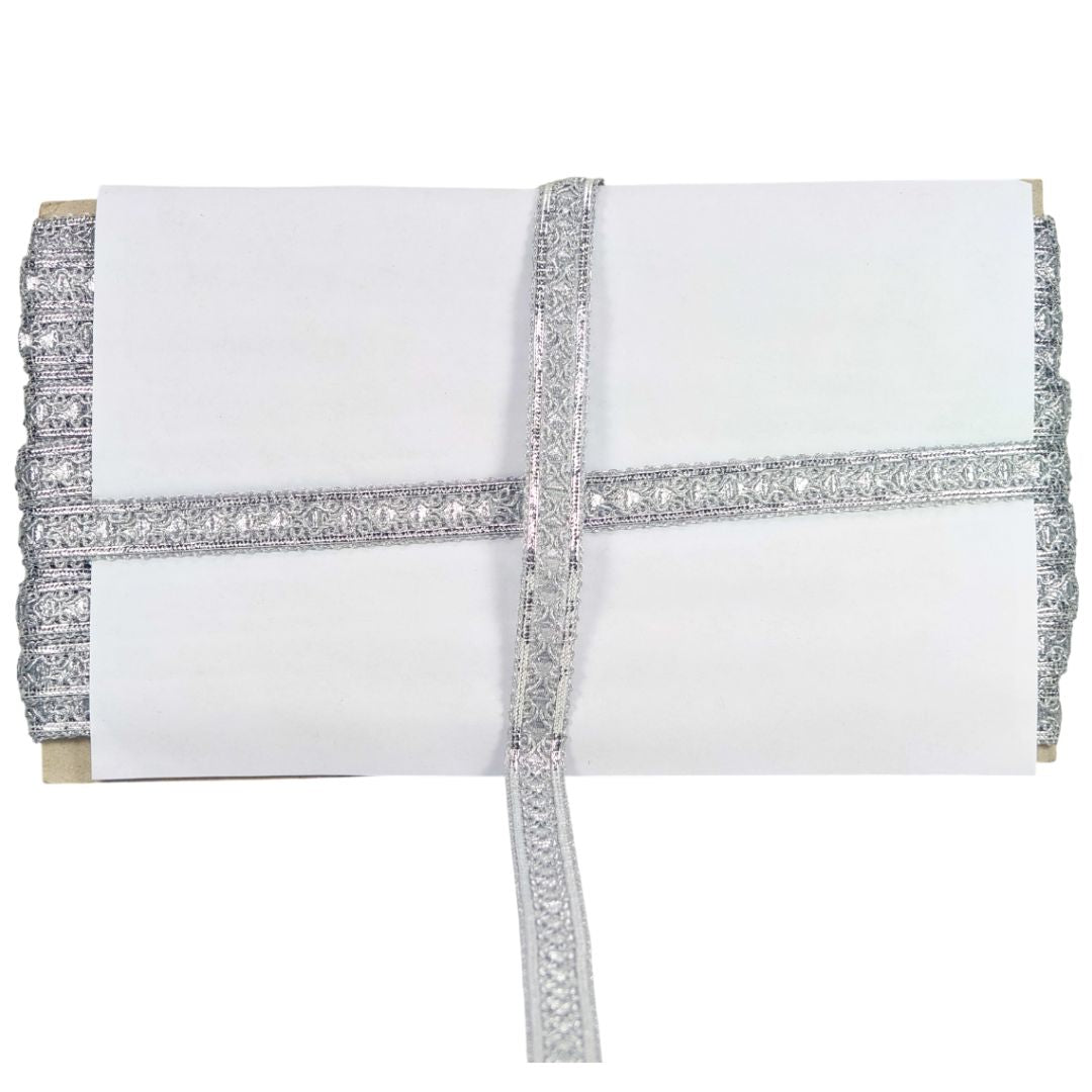 White clutch with silver beaded trim on a white background