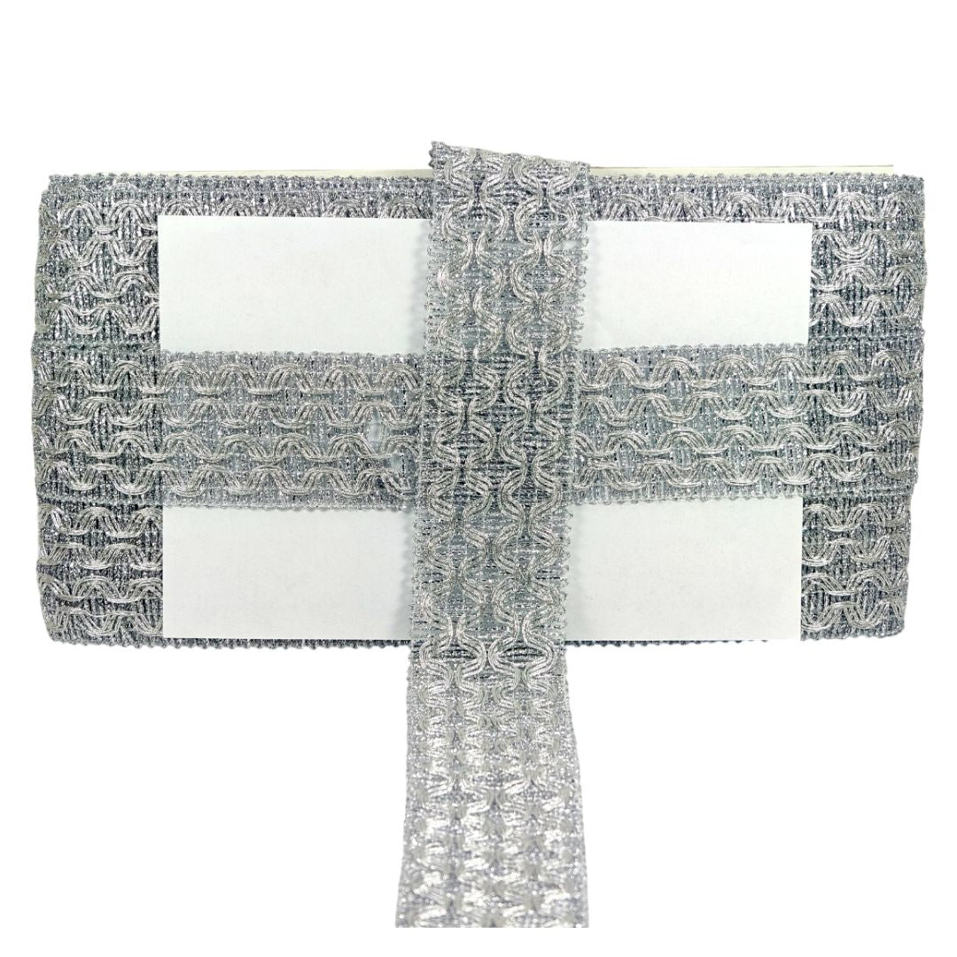 Decorative silver and white table runner on a white background