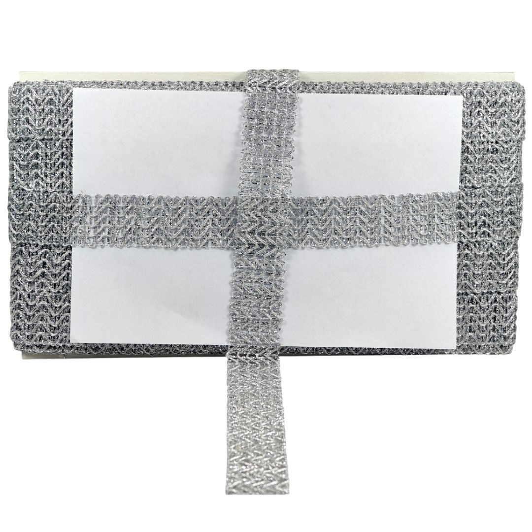 Gray mesh scrubber with white foam pad on a white background