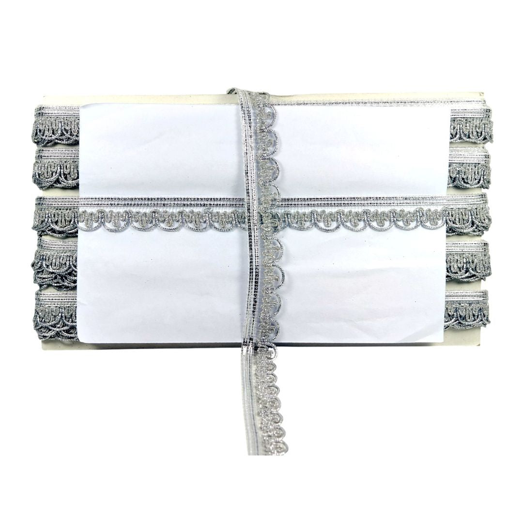 White clutch with silver embellishments on a white background