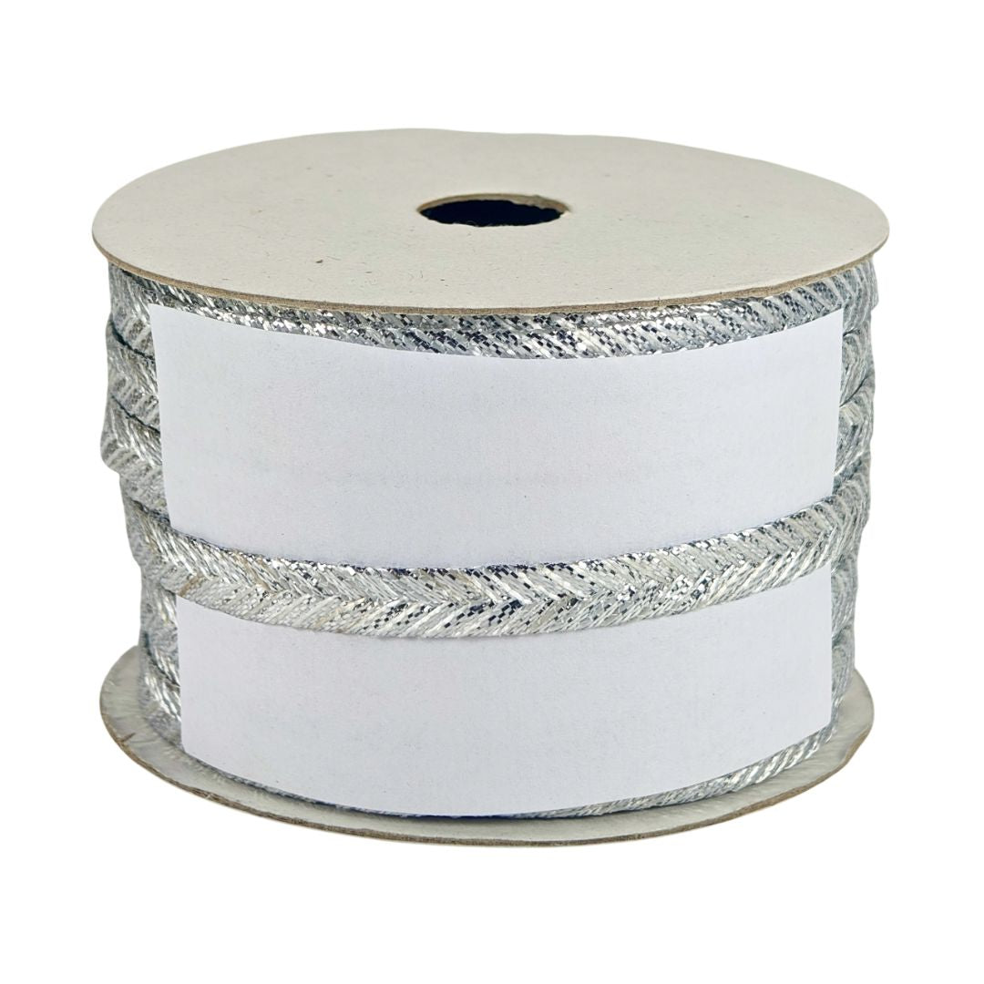 Spool of white ribbon with silver edge on a white background