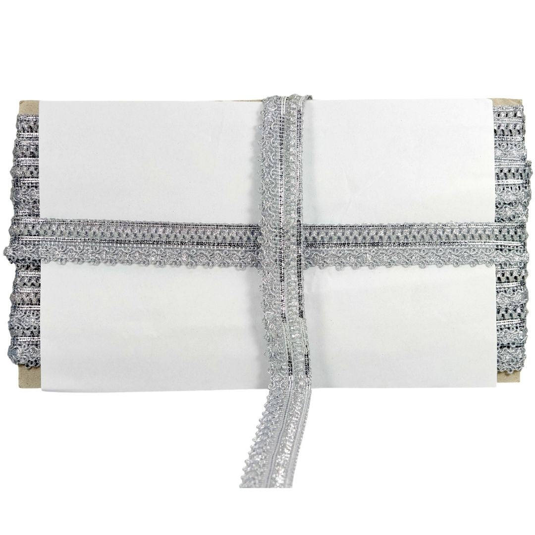 White clutch with silver beaded trim on a white background
