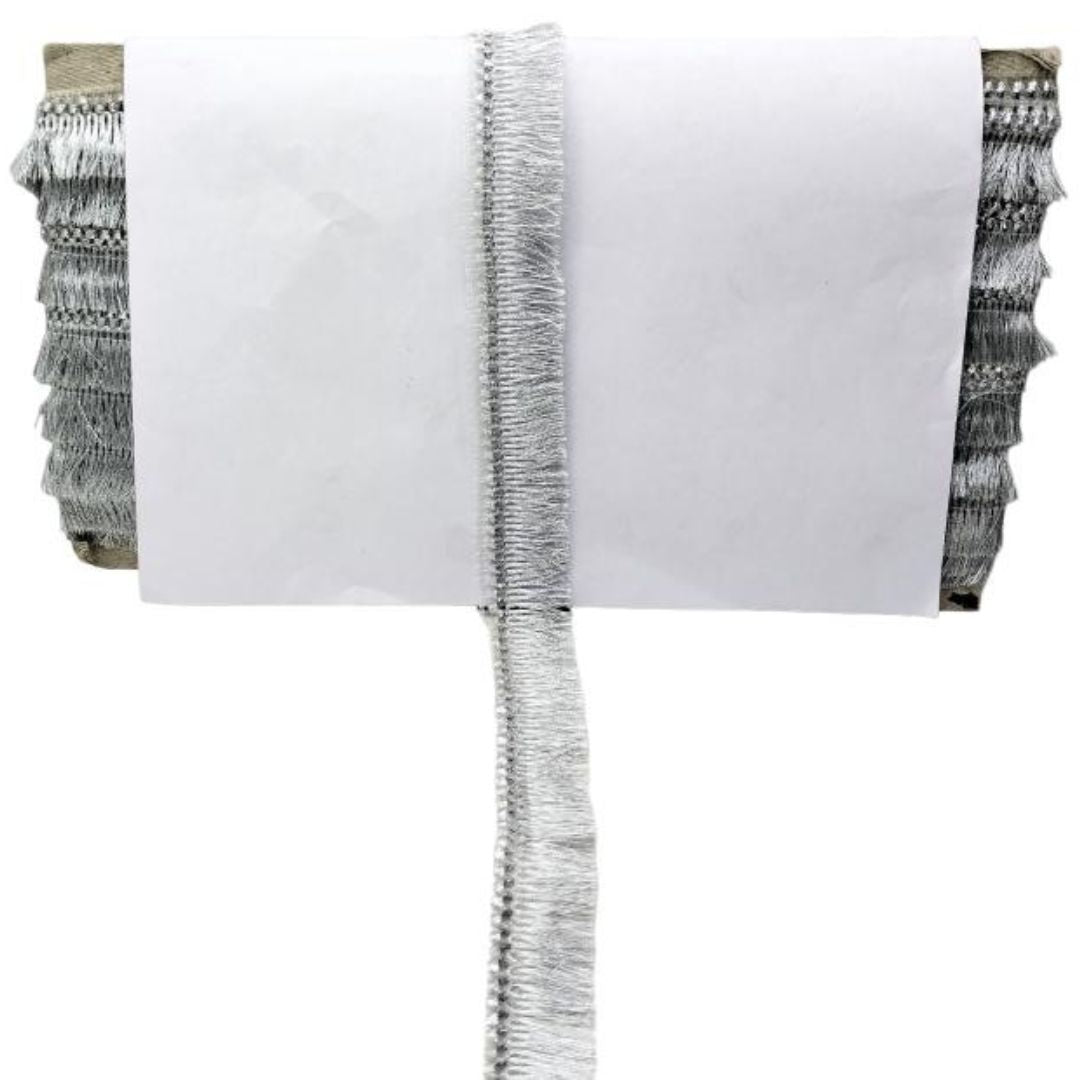 White pillow with decorative ruffle on a white background