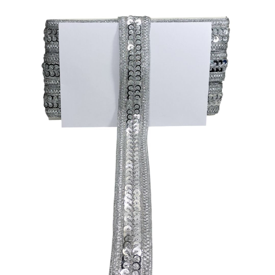 Decorative ribbon with sequins and beads on a white background