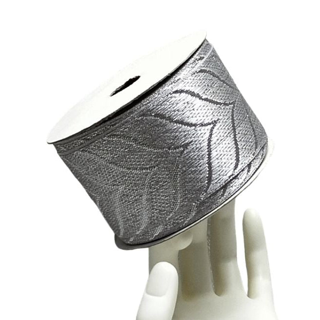 Decorative lampshade with leaf pattern on a white mannequin head against a white background