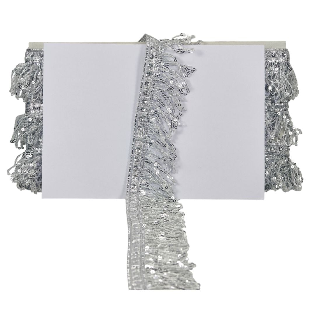 Silver tinsel and sequin trim on a white background