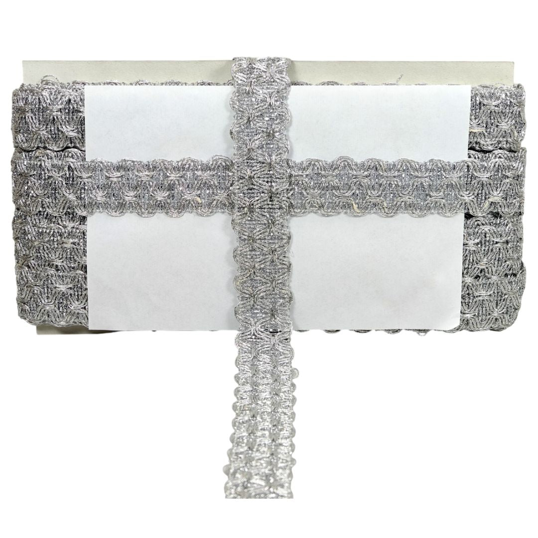 Silver clutch bag with lace detailing on a white background