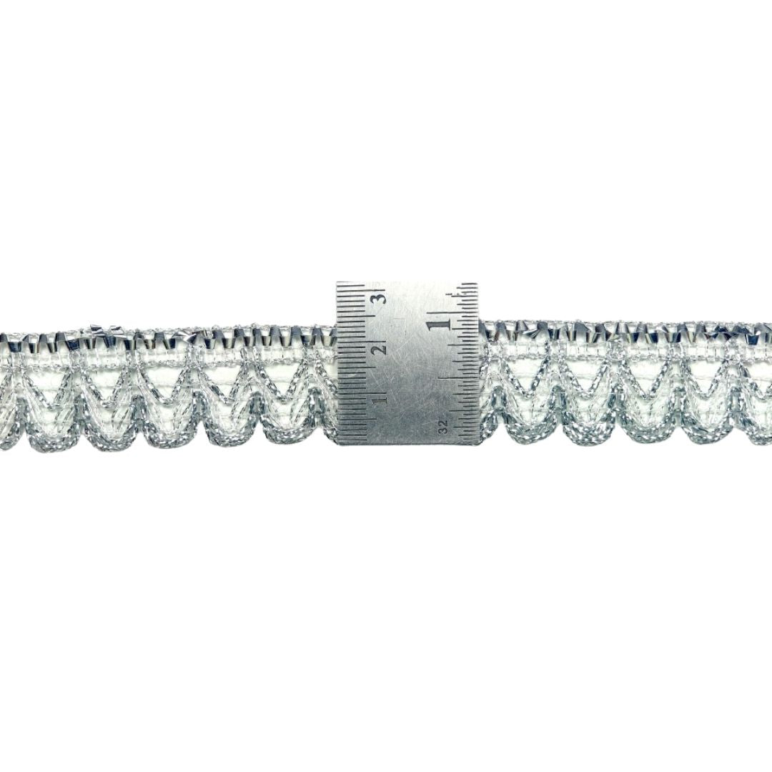 Metallic lace trim with a ruler for measurement on a white background