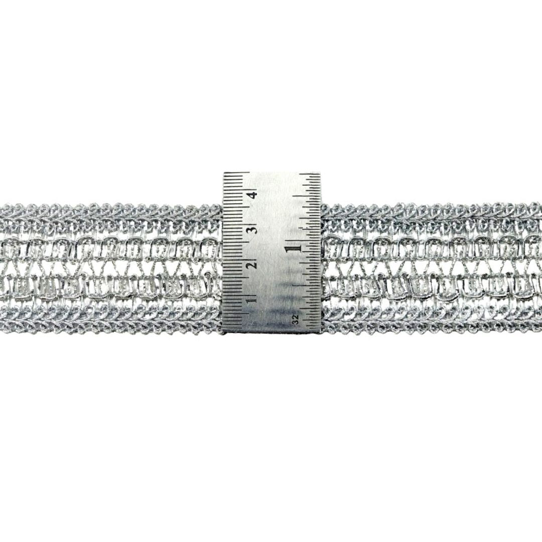 Silver chain with a ruler for scale on a white background