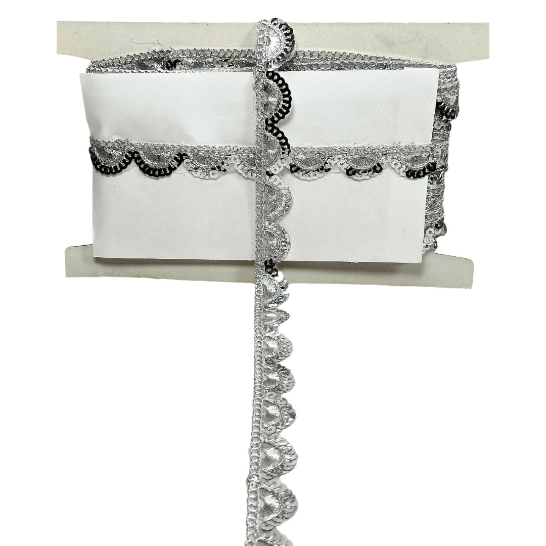 Decorative silver lace ribbon on a white background