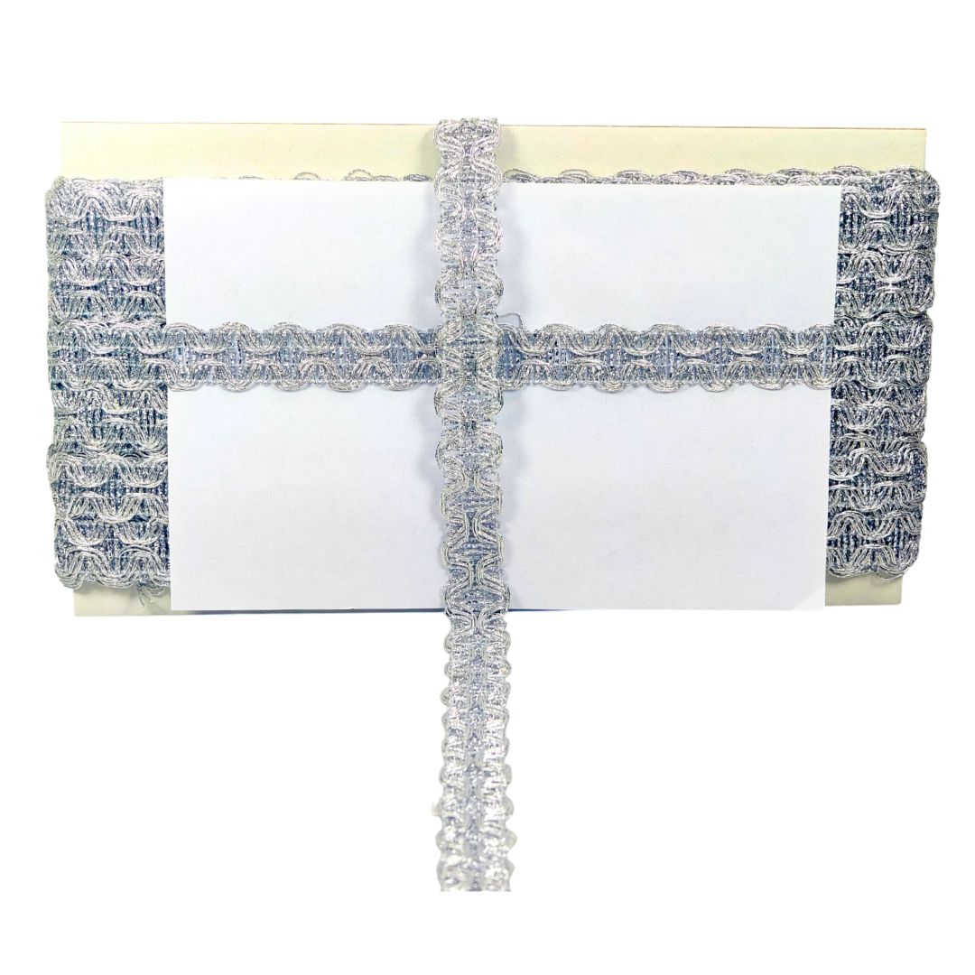 White clutch with silver lace detailing on a white background