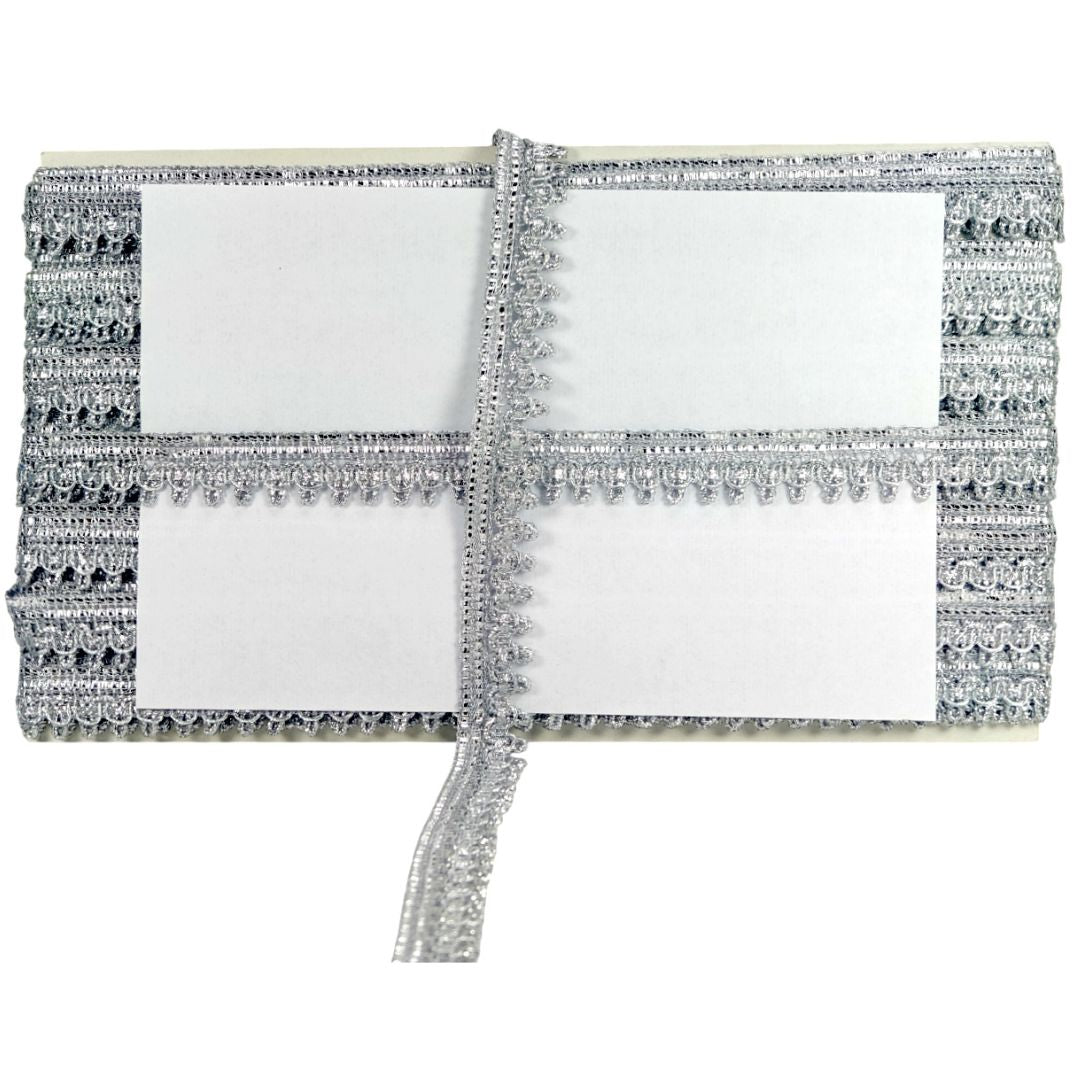 Silver clutch with decorative trim on a white background