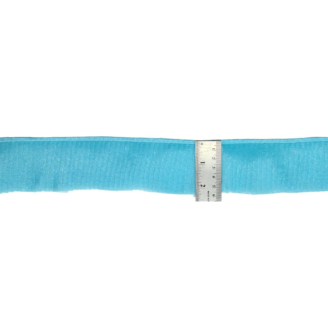 Blue ribbon with a ruler for measurement on a white background