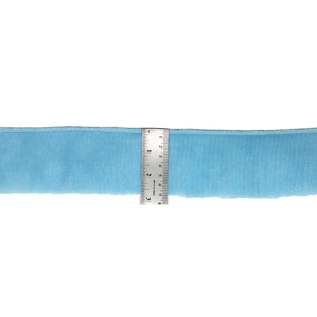 Light blue ribbon with a ruler for scale on a white background