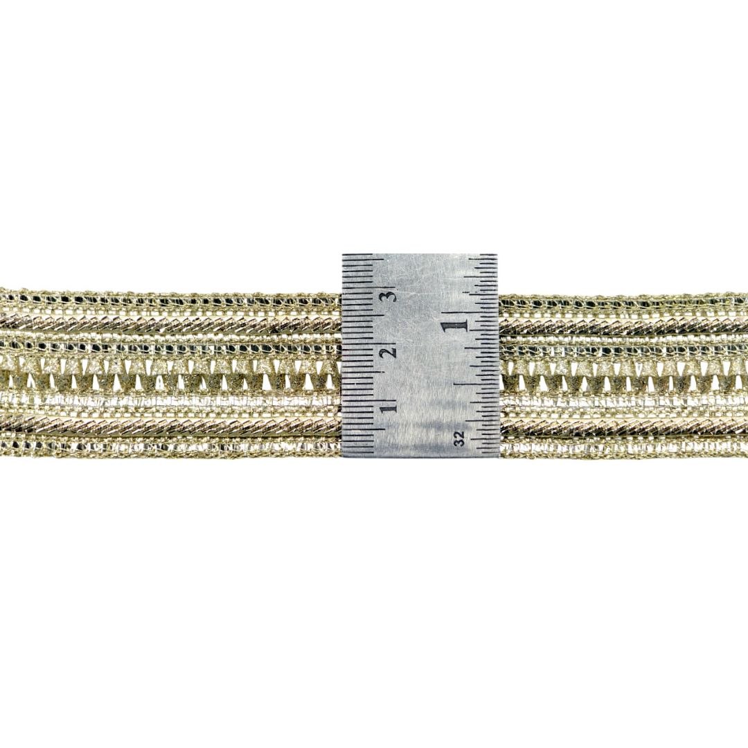 Gold braided cord with a ruler for measurement on a white background