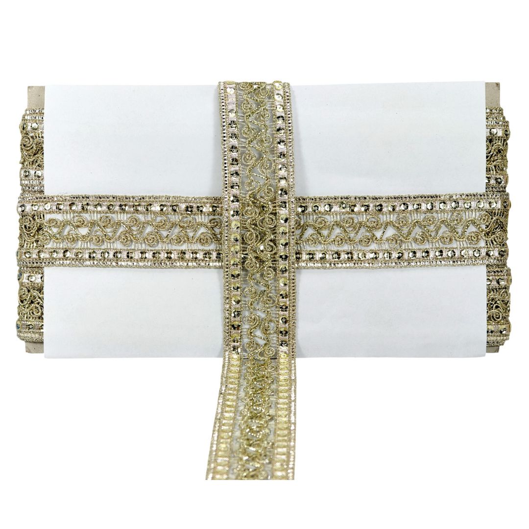 White clutch with gold beaded strap on a white background