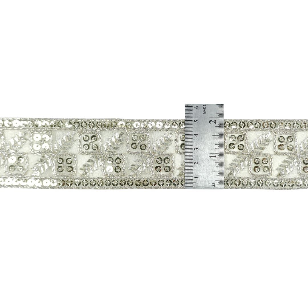 Decorative ribbon with a ruler for scale on a white background