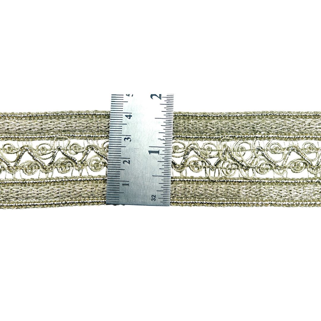 Decorative lace trim with a ruler for scale on a white background