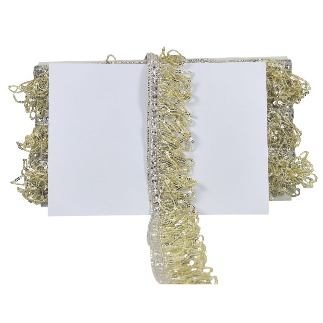 White clutch with gold fringe and embellishments on a white background