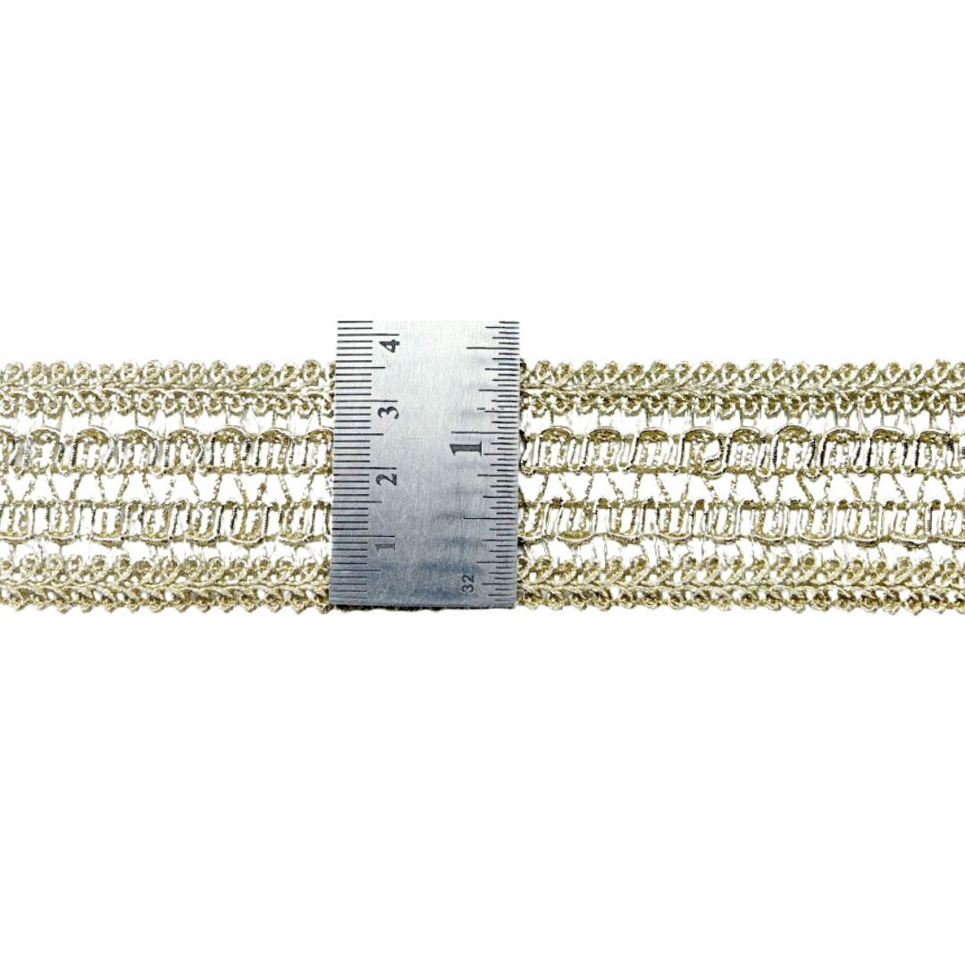 Gold chain with a ruler for scale on a white background