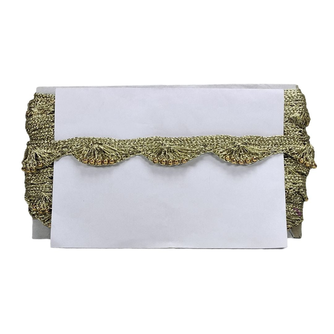 White clutch with gold decorative trim on a white background