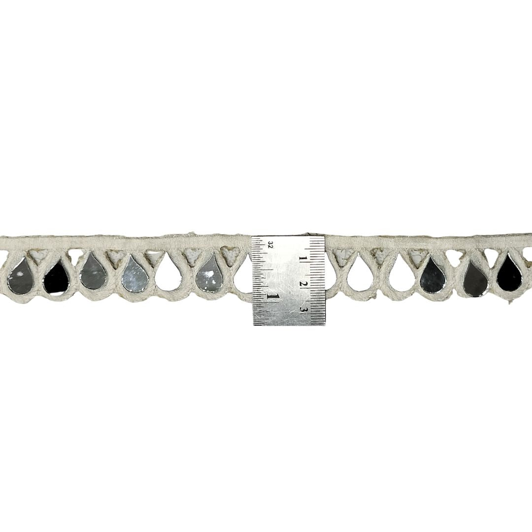 Decorative metal cornice with a ruler for scale on a white background