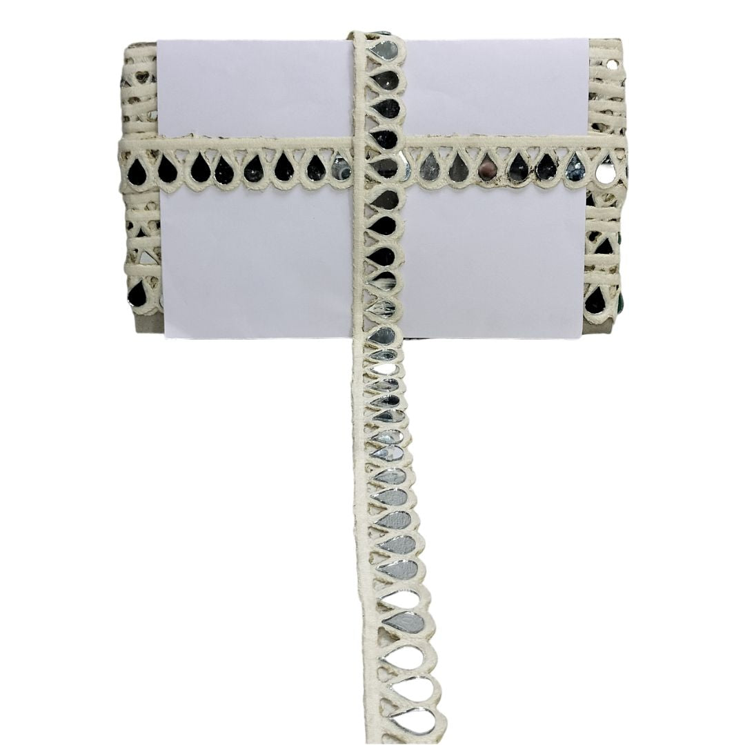 Decorative white ribbon with black and silver embellishments on a white background