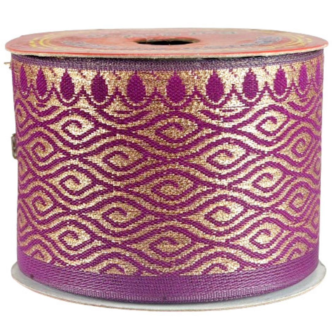 Spool of purple and gold patterned ribbon